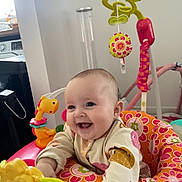 Lyla-Mae joined the competition — help win amazing prizes! baby, smiling, child, toy, activity_center, indoor, colorful, playful, happy, infant, clothing, face, cute, fun, person, seat, pattern, bright, joyful, young