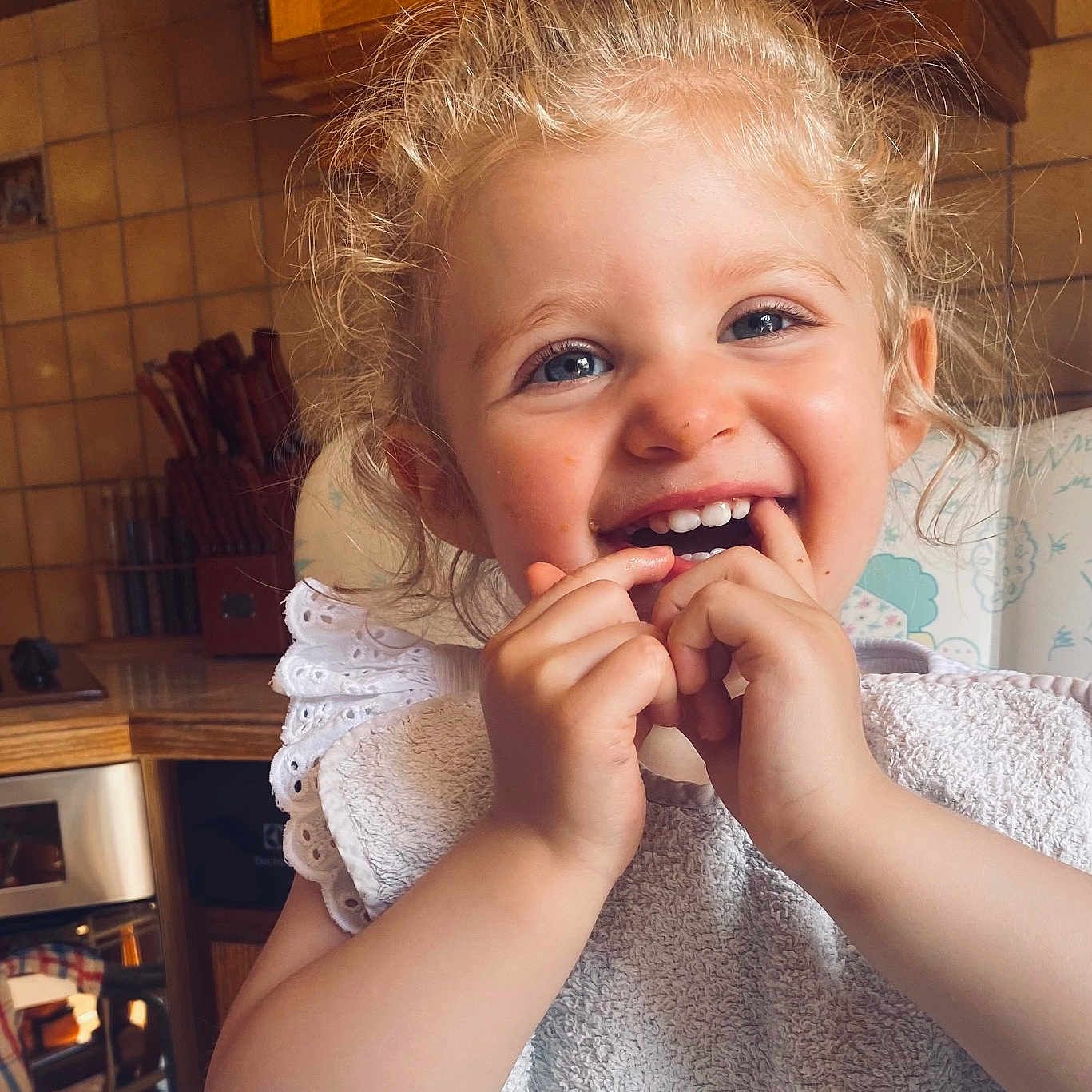Mia participe au concours pour gagner de l'argent avec cette photo : baby, bodypart, closet, cupboard, cutlery, eating, face, finger, food, furniture, hand, happy, head, laughing, mouth, person, photography, portrait, smile, teeth