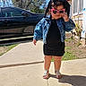 Kylie joined the competition — help win amazing prizes! toddler, child, sunglasses, heart_shaped, denim_jacket, black_dress, sandals, sidewalk, outdoor, sunny, shadow, grass, tree, car, house, window, plants, fashion, cute, attitude