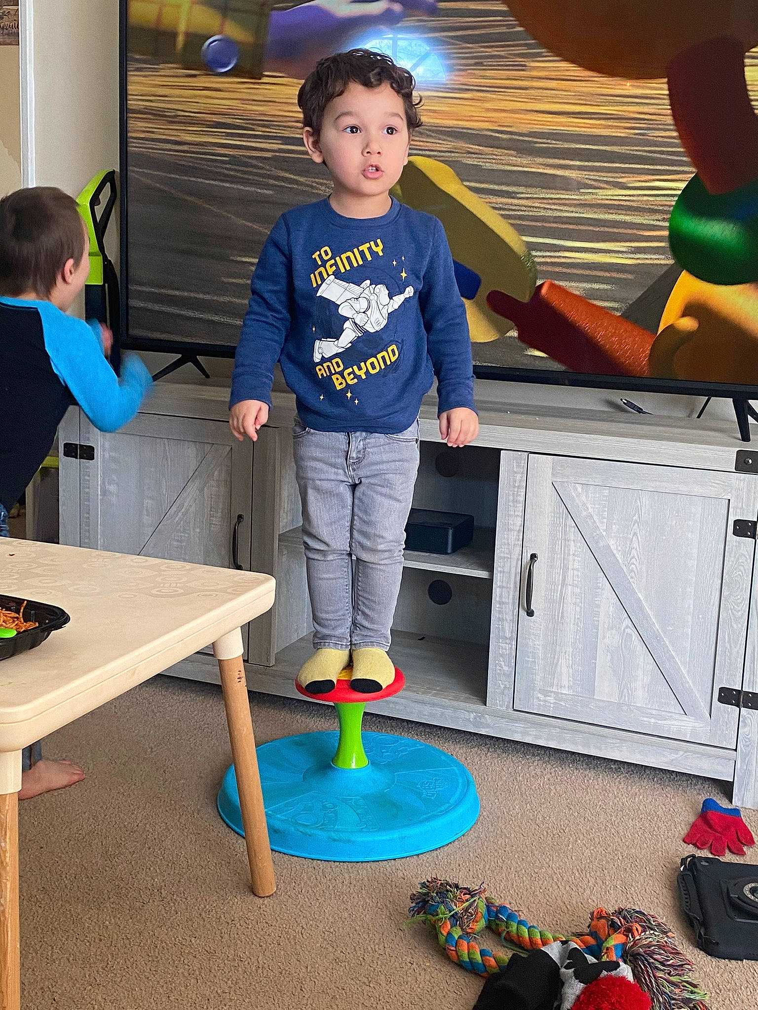 Gabriel is registered to the contest to win money with this photo: blue, child, electric_blue, fun, games, happy, leisure, party_supply, person, play, recreation, recreation_room, room, sharing, space, standing, t_shirt, table, toddler, visual_arts