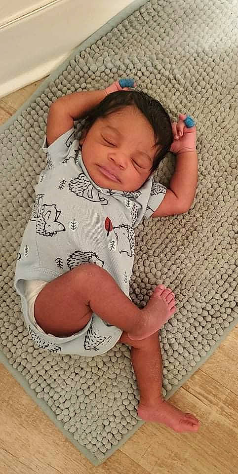 Keith joined the competition — help win amazing prizes! baby, baby_toddler_clothing, cheek, comfort, eye, face, facial_expression, finger, floor, flooring, head, human_body, neck, nose, person, skin, sleeve, sock, textile, thigh