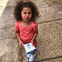 Londynn joined the competition — help win amazing prizes! child, girl, curly_hair, pink_clothing, sneakers, sidewalk, outdoor, playful_face, winking, pamphlet, paper, standing, smile, hair_tie, casual_clothing, person, footwear, concrete, summer, cute