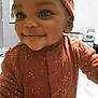 Isabella joined the competition — help win amazing prizes! baby, child, smile, face, head_wrap, clothing, onesie, indoor, person, cute, happy, infant, closeup, portrait, apparel, warm_colors, expression, young_child, baby_girl, adorable