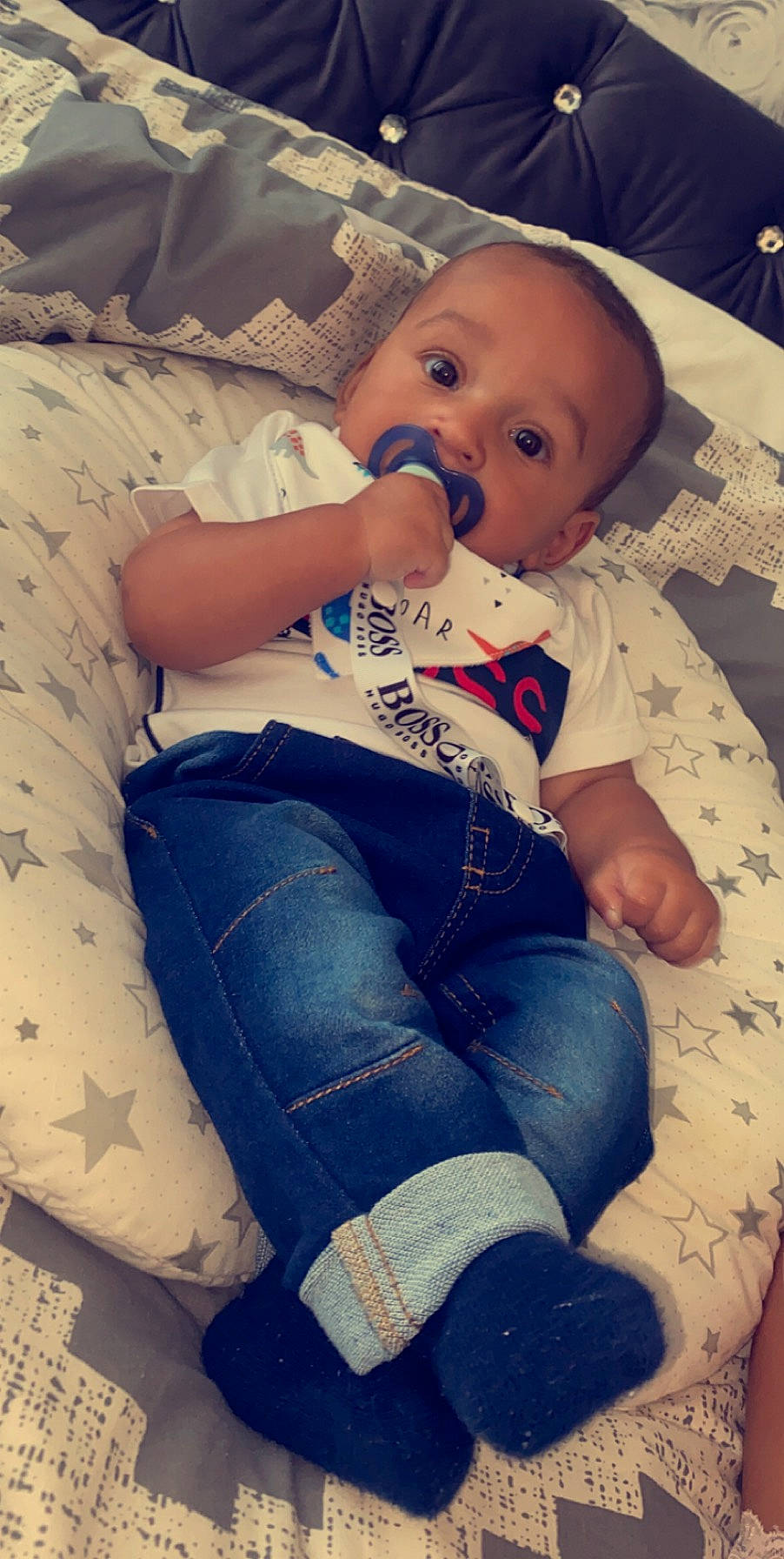 Manny is registered to the contest to win money with this photo: arm, baby, cheek, child, leg, nose, person, sitting, skin, textile, toddler