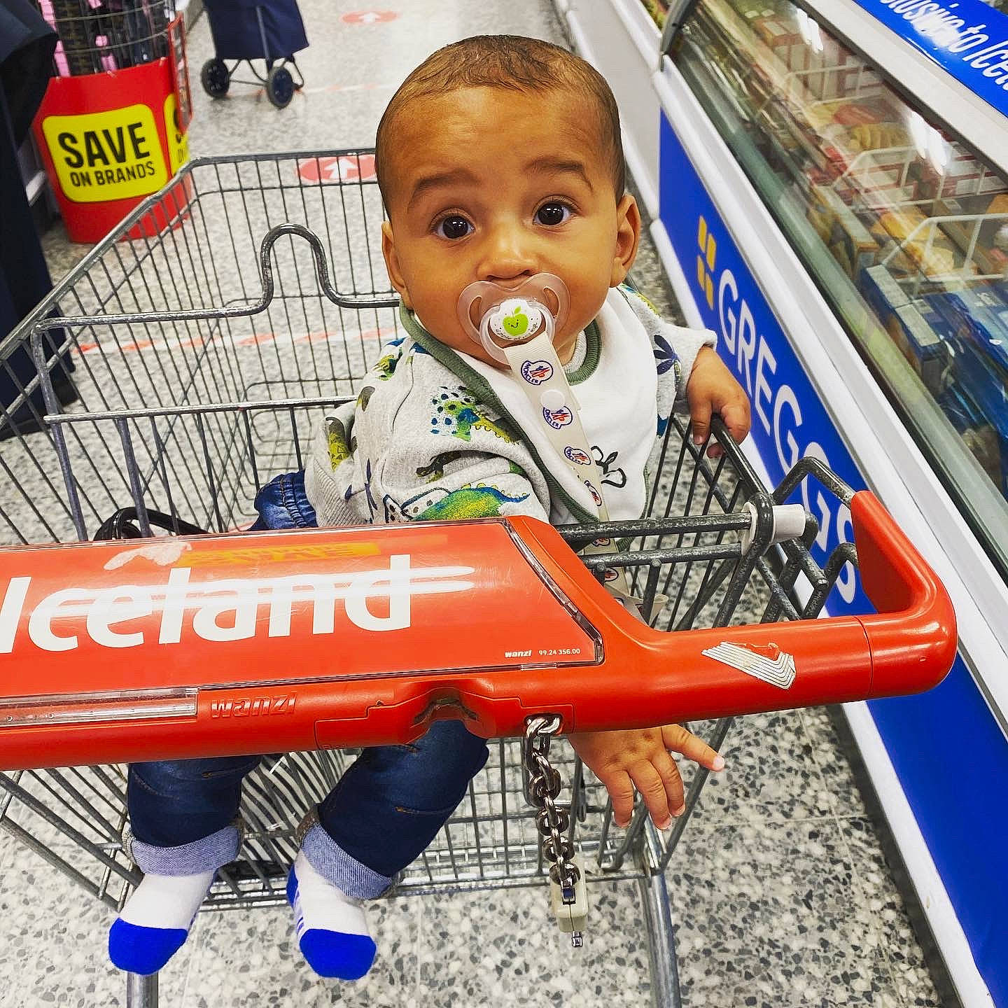 Manny is registered to the contest to win money with this photo: advertising, child, grocery_store, person, shopping_cart, supermarket, surprise, toddler, vehicle