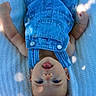 Briar joined the competition — help win amazing prizes! baby, denim_overalls, blue_clothing, white_blanket, infant, tongue_out, playful, cute, happy, baby_arms, baby_face, portrait, texture, sunlight_spots, outdoor, child, clothing, smiling, young_child, lying_down