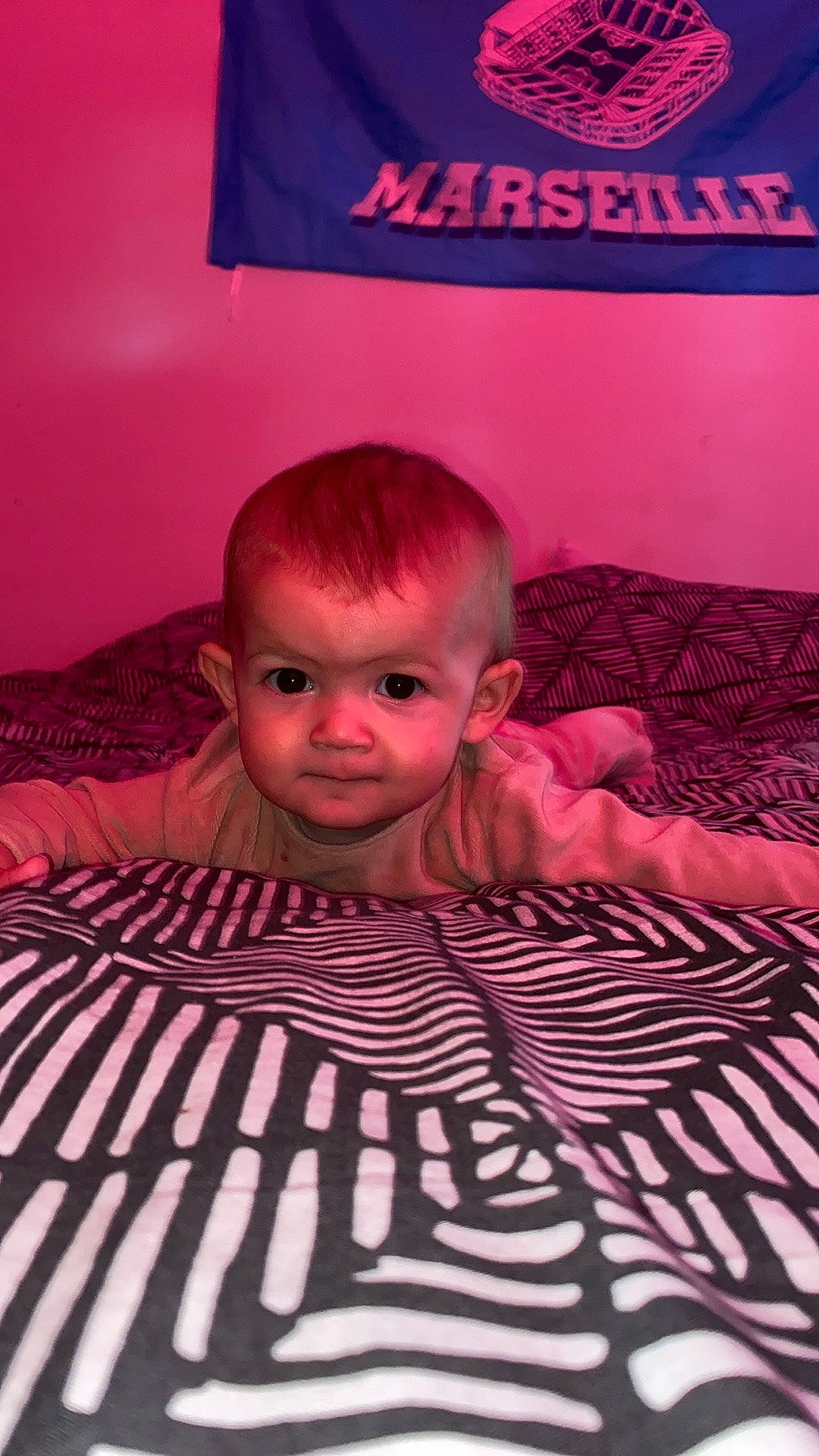 élizéa participe au concours pour gagner de l'argent avec cette photo : baby, baby_toddler_clothing, bedding, child, chin, comfort, flash_photography, flooring, font, linens, logo, magenta, pattern, person, pink, purple, room, sleeve, t_shirt, textile