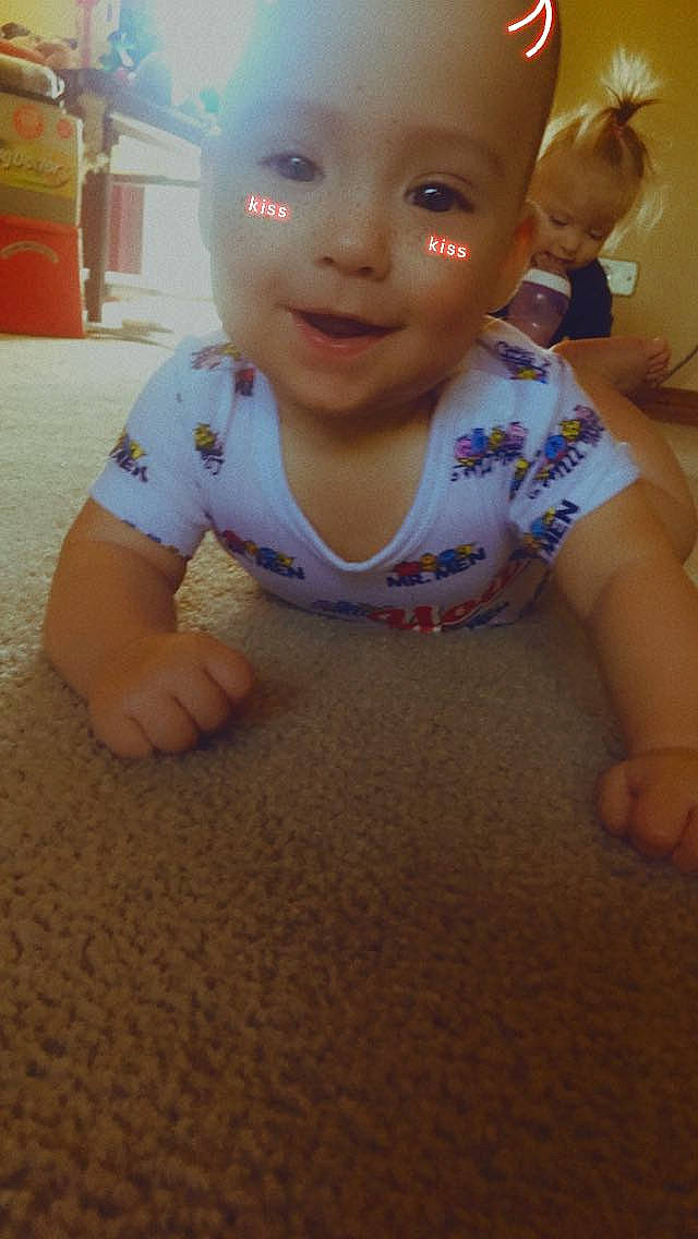 Dustin is registered to the contest to win money with this photo: baby, baby_toddler_clothing, cheek, chin, eye, facial_expression, finger, floor, flooring, fun, happy, human_body, iris, mouth, nose, person, skin, sleeve, smile, toddler