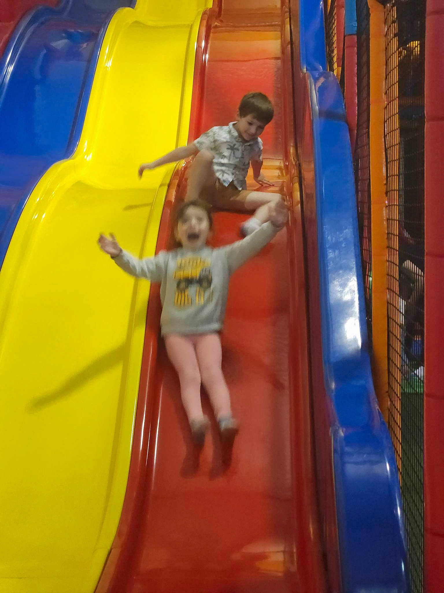 Imogen is registered to the contest to win money with this photo: amusement_park, automotive_exterior, baby_toddler_clothing, bumper, child, chute, city, electric_blue, fun, leisure, nonbuilding_structure, outdoor_play_equipment, person, play, playground, playground_slide, recreation, shorts, smile, t_shirt