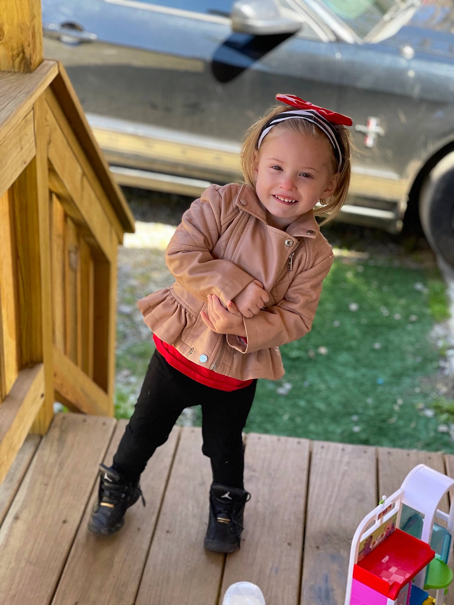 Aryah is registered to the contest to win money with this photo: automotive_tire, car, child, family_car, flooring, fun, grass, hat, jacket, joy, leisure, motor_vehicle, person, recreation, tire, toddler, vehicle, vehicle_door, wheel, white