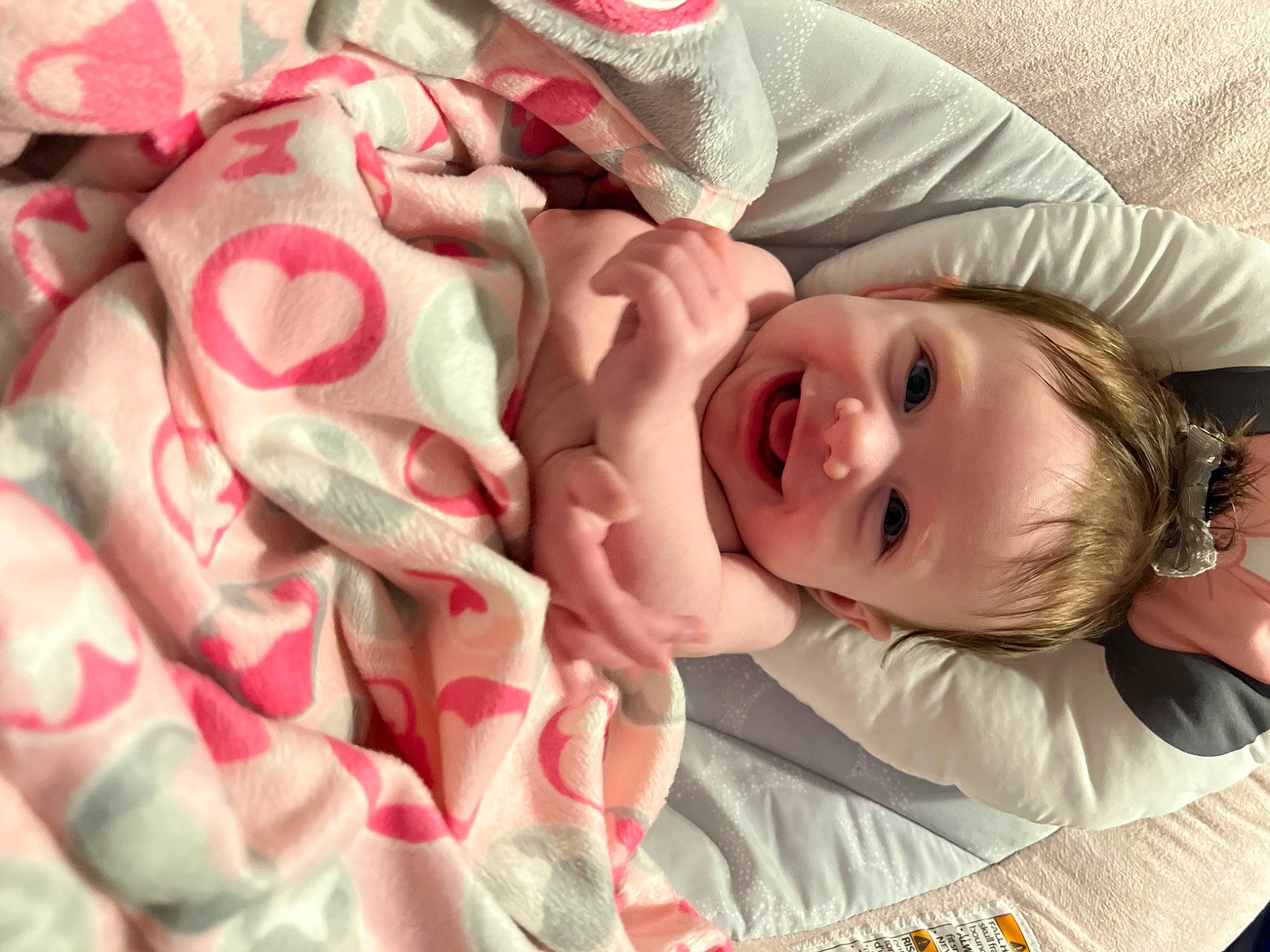 Everleigh joined the competition — help win amazing prizes! baby, baby_toddler_clothing, cheek, child, close_up, comfort, event, face, happy, hat, headgear, human_body, joy, linens, lip, mouth, nose, person, pink, skin