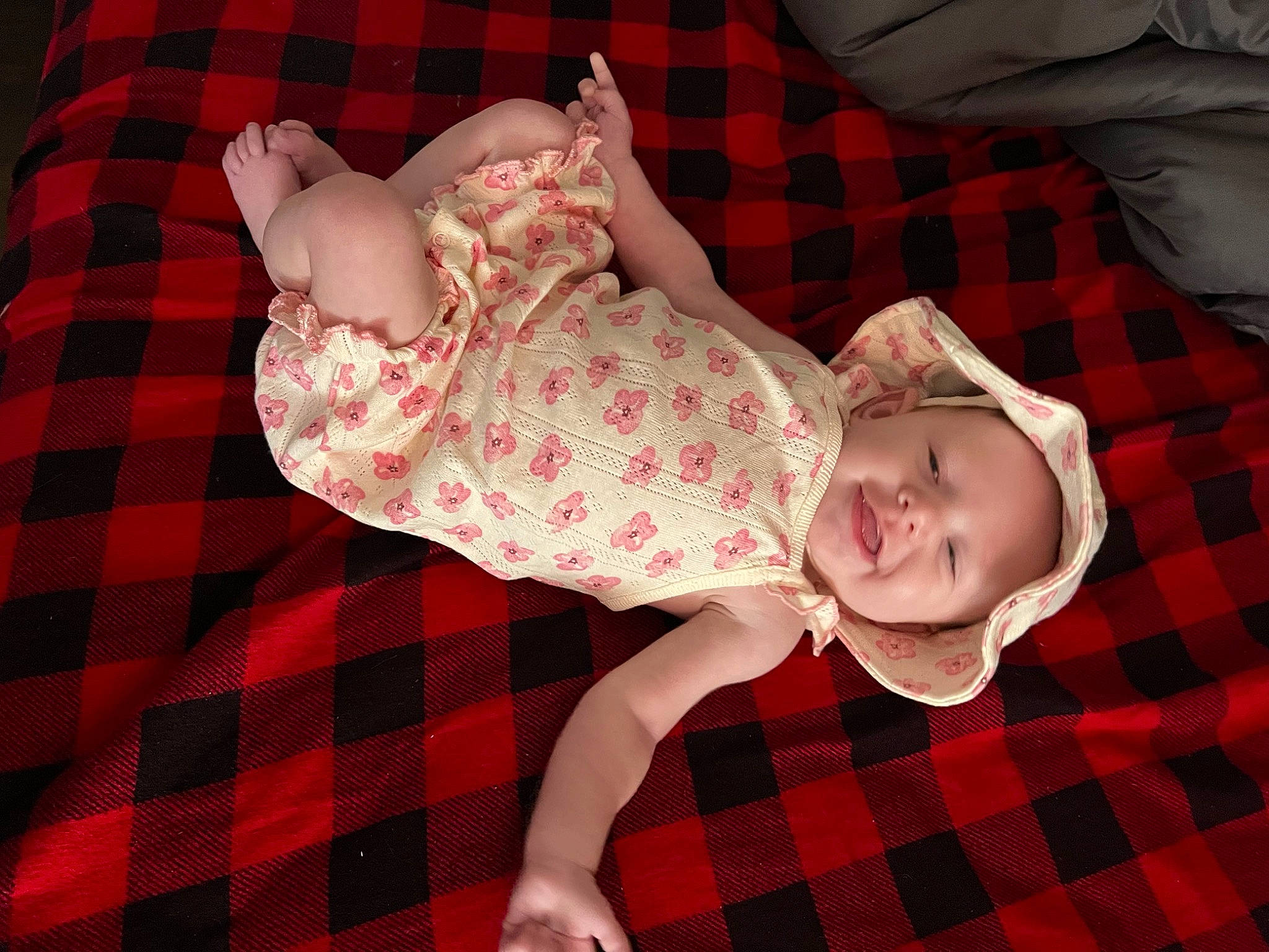 Everleigh is registered to the contest to win money with this photo: baby, baby_toddler_clothing, child, collar, comfort, design, dress, headwear, human_body, joy, linens, pattern, person, pink, plaid, red, skin, sleeve, smile, tartan