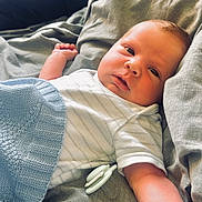 Luca joined the competition — help win amazing prizes! baby, infant, pacifier, blanket, bed, sheet, gray, blue, knitted, sleepwear, lying_down, arm, face, skin, indoor, cute, child, resting, cozy, soft