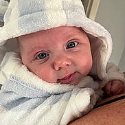 Luca joined the competition — help win amazing prizes! baby, infant, face, blue_eyes, hood, fluffy_clothing, cute, portrait, close_up, child, soft_texture, skin, human, person, newborn, baby_clothes, expression, looking_at_camera, indoor, holding