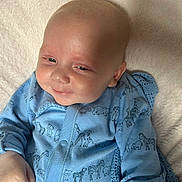 Luca joined the competition — help win amazing prizes! animal_print, apparel, baby, baby_clothes, blanket, blue_onesie, child, closeup, comfort, cute, face, hand, head, infant, lying_down, portrait, relaxed, skin, smile, soft_texture