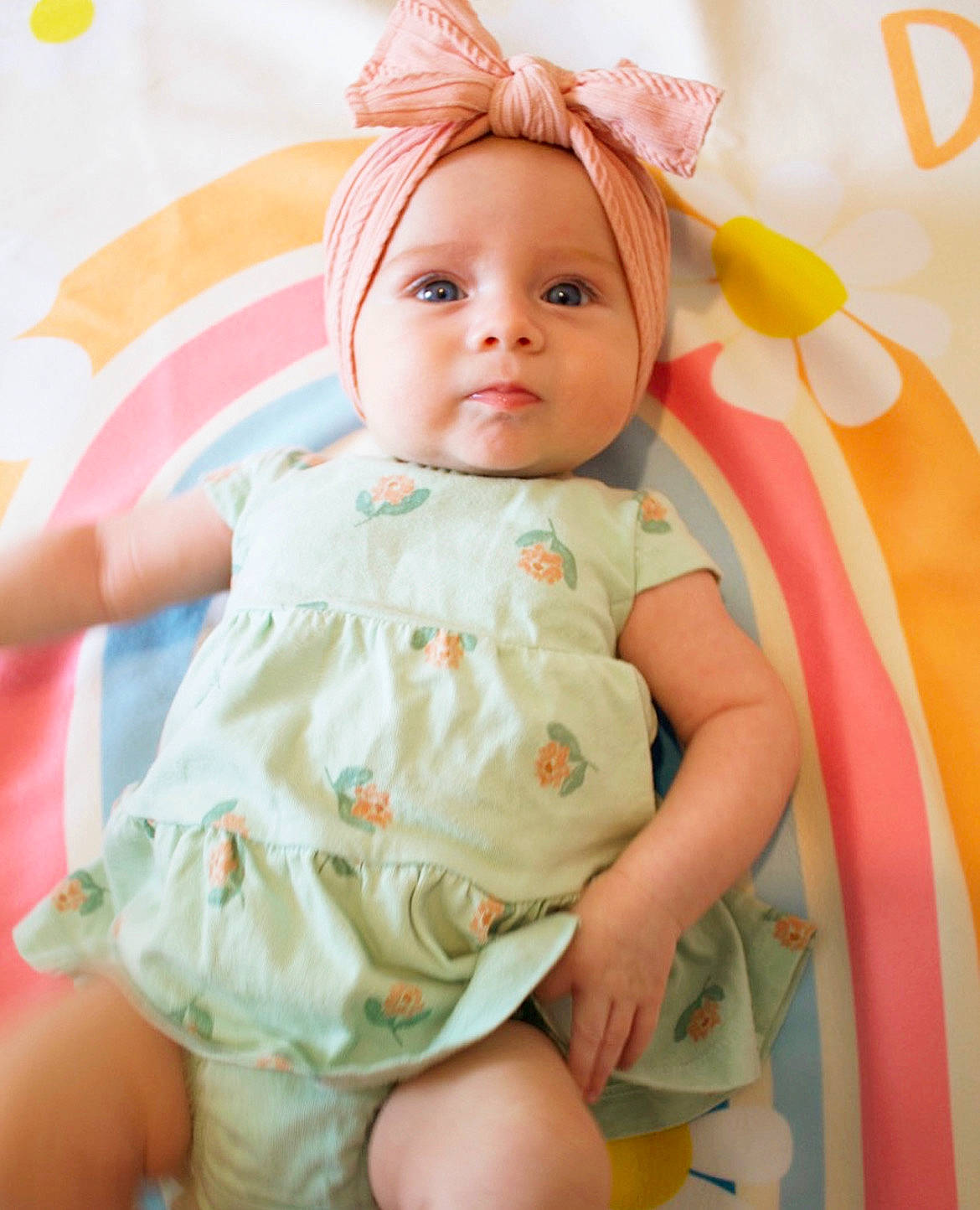 Drew is registered to the contest to win money with this photo: baby, baby_products, baby_toddler_clothing, blond, cheek, child, dress, eyelash, fashion_accessory, happy, headband, headpiece, headwear, linens, pattern, peach, person, pink, skin, sleeve