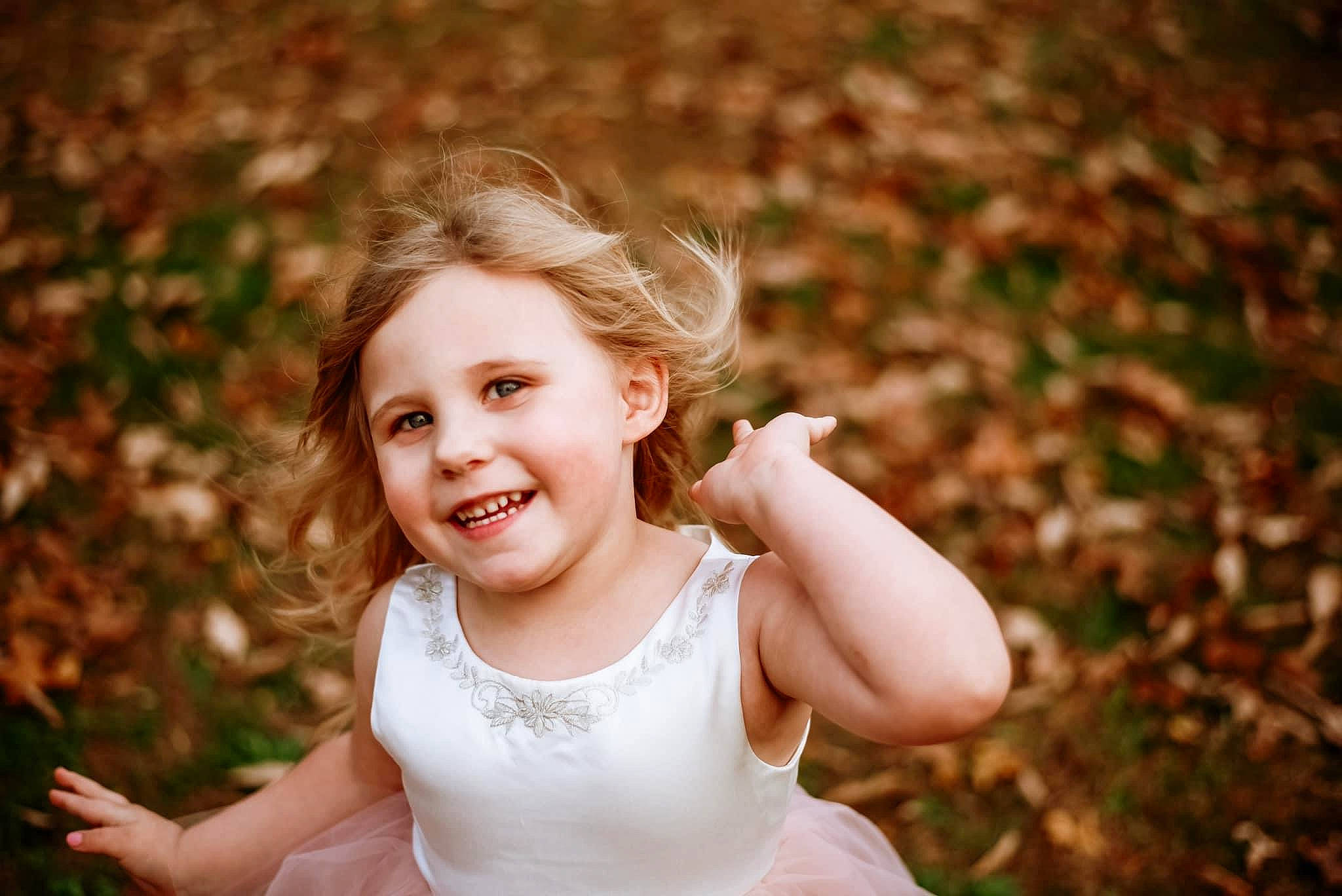 Kendall is registered to the contest to win money with this photo: blond, brown_hair, child, face, flash_photography, fun, gesture, grass, happy, head, joy, leaf, mammal, people_in_nature, person, plant, skin, smile, spring, sunlight