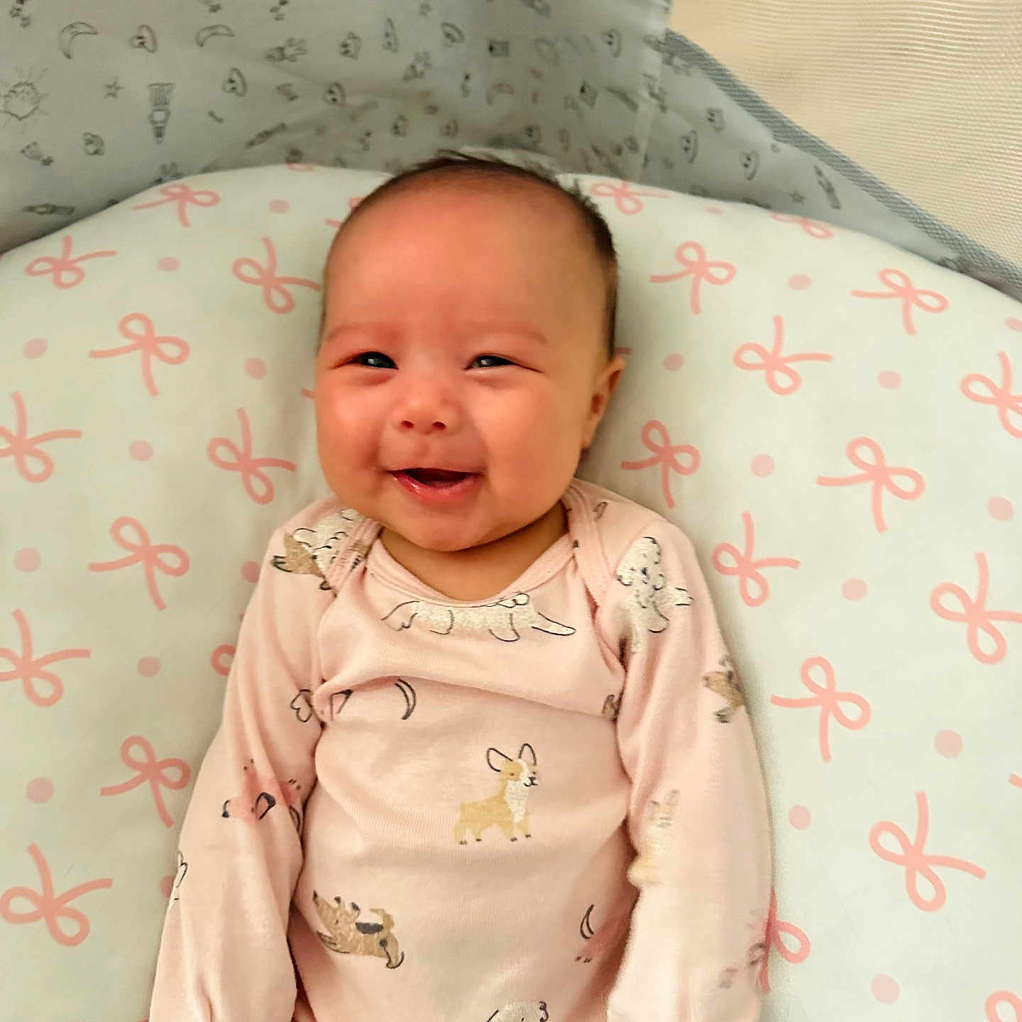 Lillianna joined the competition — help win amazing prizes! adorable, baby, baby_girl, child, comfort, cushion, cute, dog_pattern, face, happy, indoors, infant, lying_down, onesie, pink_bows, pink_clothing, portrait, smiling, soft_lighting, young_child