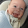 baby, smiling, face, closeup, infant, blue_clothing, bib, car_seat, seatbelt, child, happy, cute, young, skin, head, person, portrait, indoor, safety_warning, seat