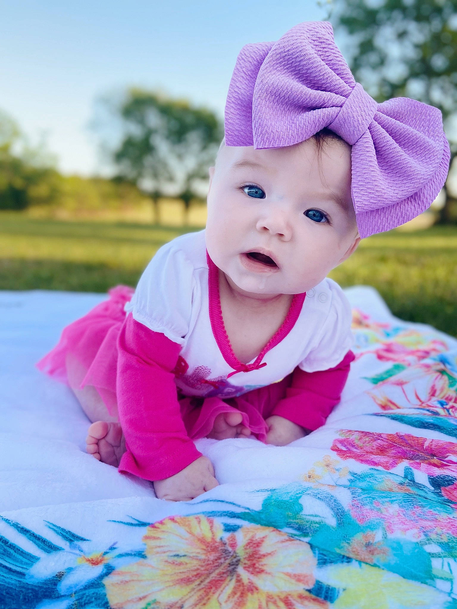 Laikyn is registered to the contest to win money with this photo: baby, baby_toddler_clothing, dress, eye, face, facial_expression, grass, happy, headgear, headwear, outerwear, people_in_nature, person, photograph, pink, plant, product, purple, skin, sleeve