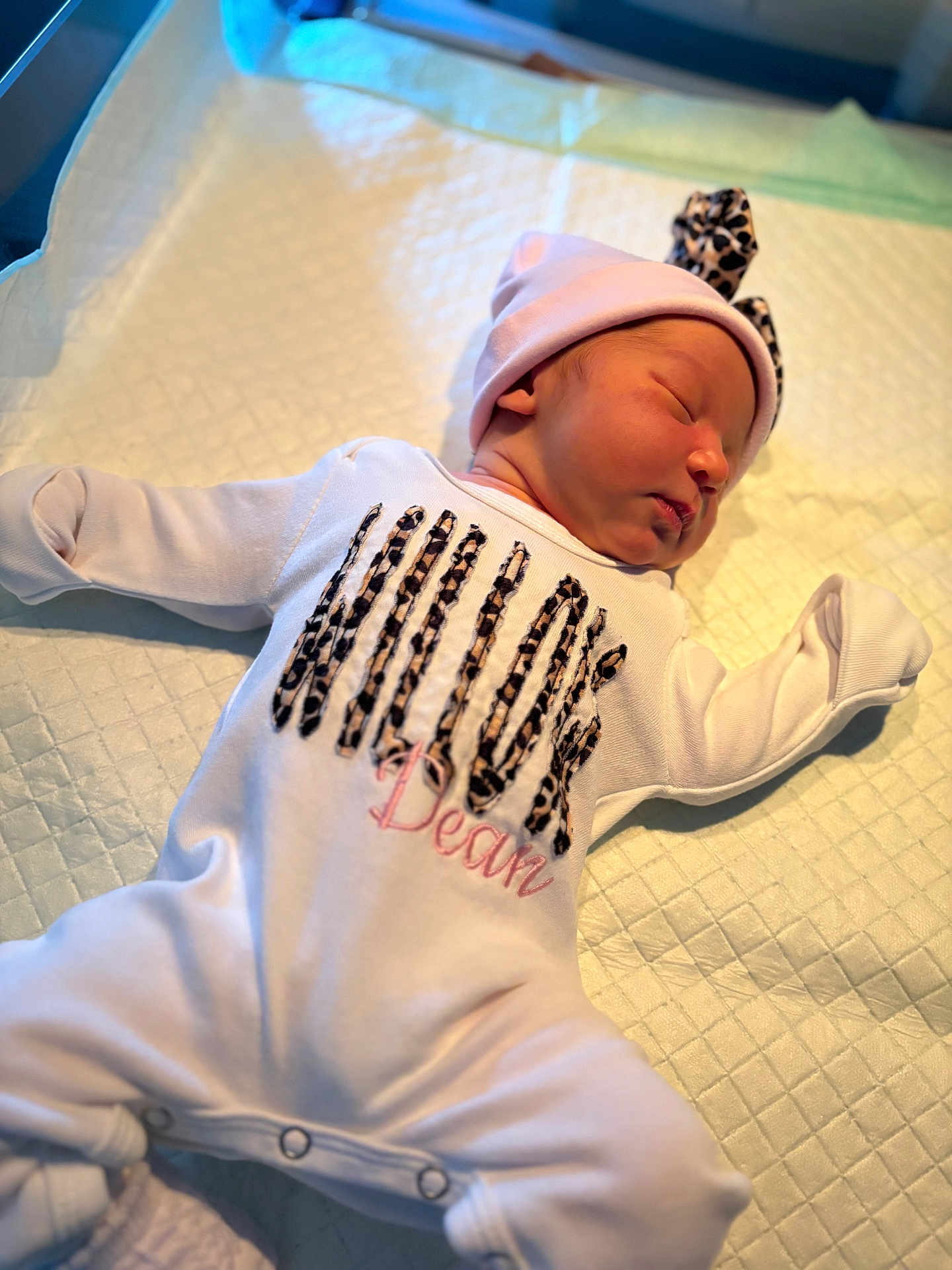 Willowdean is registered to the contest to win money with this photo: newborn, baby, infant, sleeping, onesie, hat, headband, leopard_print, blanket, changing_pad, nursery, portrait, cute, cheeks, peaceful, pajamas, hospital, soft_lighting, small_person, laying_down