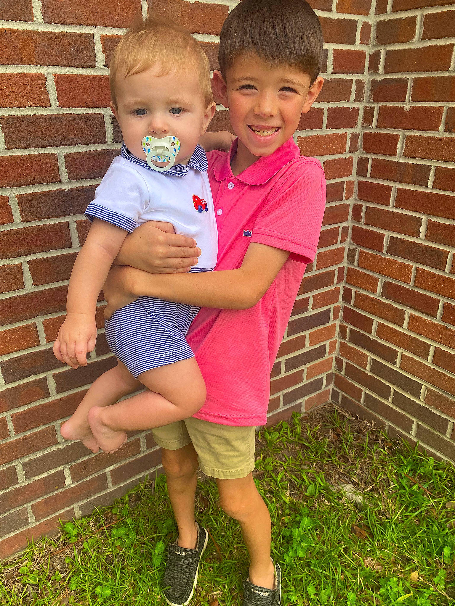 Conner joined the competition — help win amazing prizes! brick, brickwork, child, cool, eye, face, fun, gesture, grass, happy, head, joy, people_in_nature, person, pink, sandal, shorts, smile, t_shirt, thigh