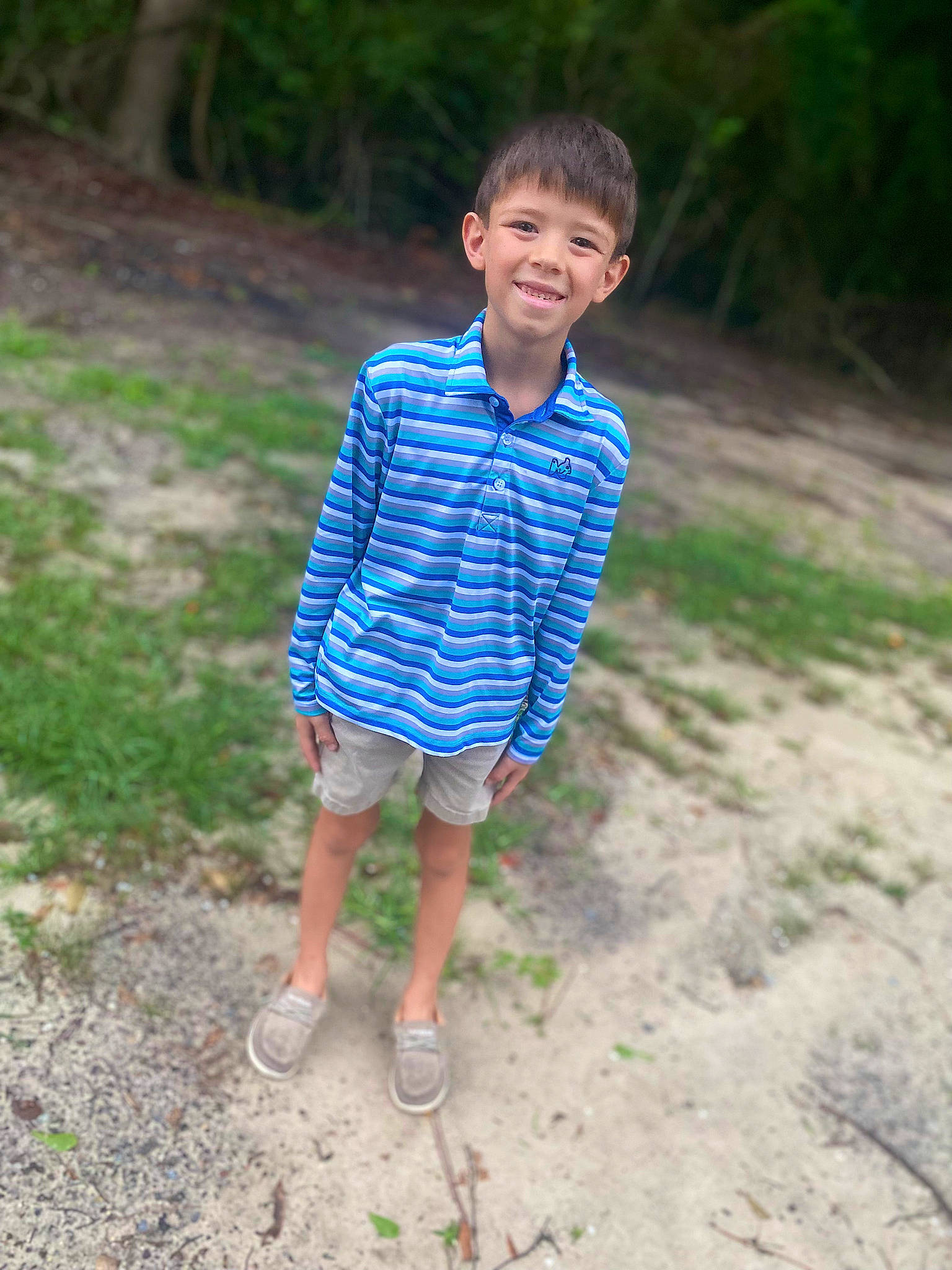 Conner is registered to the contest to win money with this photo: child, electric_blue, flip_flops, fun, grass, happy, joy, leisure, pattern, people_in_nature, person, recreation, sandal, sitting, sleeve, slipper, smile, soil, t_shirt, toddler