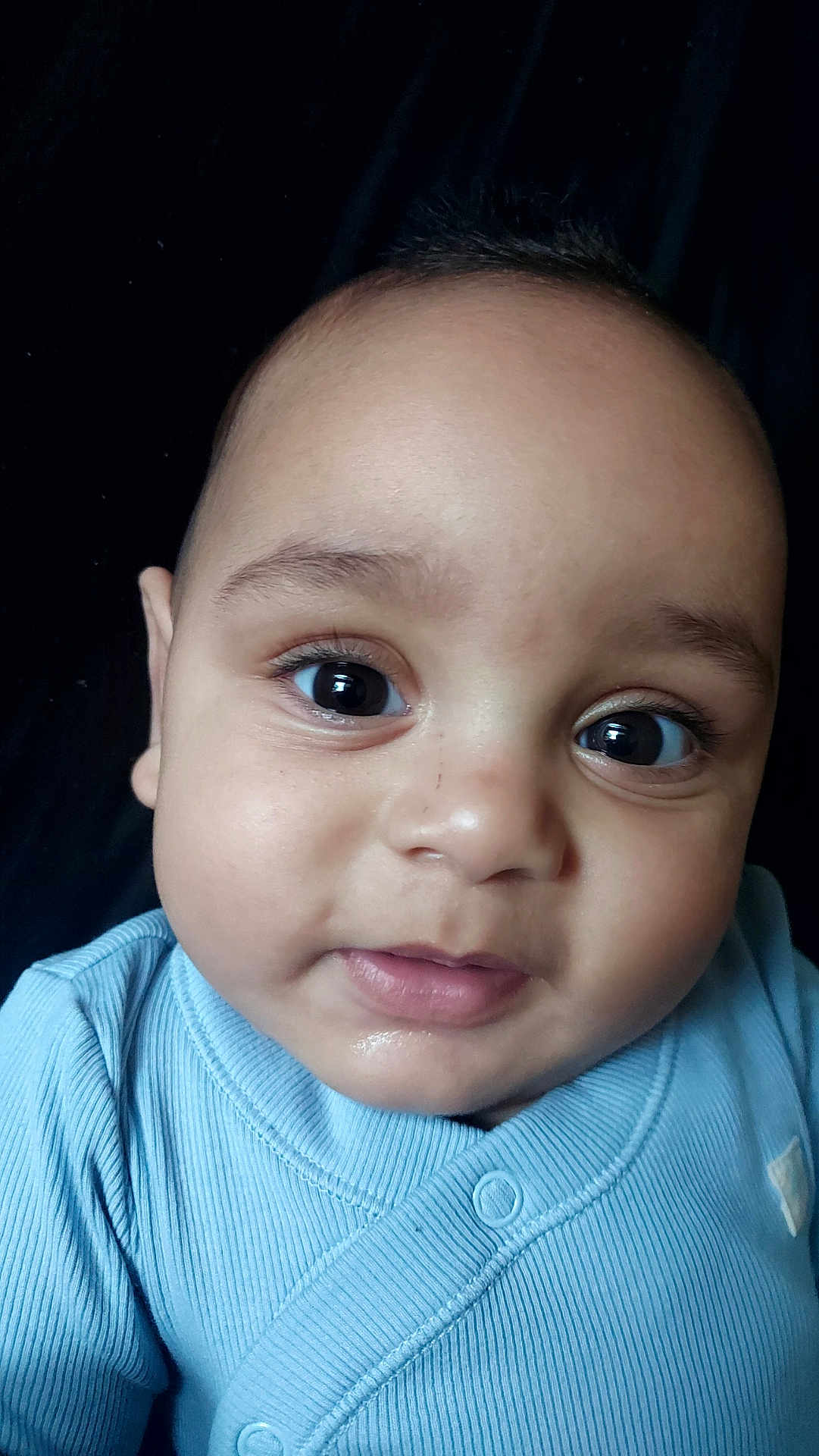 Angel is registered to the contest to win money with this photo: baby, infant, face, eyes, blue_clothing, portrait, closeup, child, cute, skin, head, expression, young, adorable, person, newborn, apparel, looking, studio, soft_light