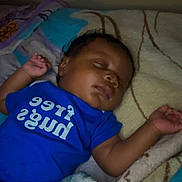 Nasiah is registered to the contest to win money with this photo: baby, bed, blanket, blue_onesie, child, comfort, cozy, curly_hair, cute, face, hand, indoors, infant, peaceful, portrait, rest, skin, sleeping, soft_lighting, toddler