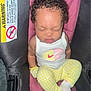 baby, infant, sleeping, curly_hair, white_tank_top, yellow_pants, car_seat, warning_label, child, cute, peaceful, indoors, clothing, sock, seat, safety, person, portrait, resting, young