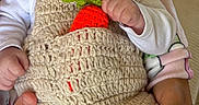 Joseph participe au concours pour gagner de l'argent avec cette photo : baby, crochet, hat, carrot, outfit, infant, hands, smile, cute, child, white_clothing, knitwear, person, portrait, seated, cozy, soft_toys, background, fabric, cute_expression