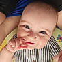 baby, infant, face, smile, hand, fingers, striped_shirt, button, pacifier_clip, blue, skin, eyes, eyelashes, cheeks, person, child, cute, closeup, fabric, colorful_background