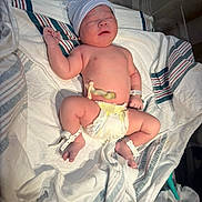 Ethan joined the competition — help win amazing prizes! newborn, baby, hospital, bassinet, diaper, umbilical_cord, hat, blanket, medical_tag, sleeping, infant, skin, wristband, ankle_band, hospital_bed, striped_blanket, cute, newborn_baby, patient, resting