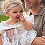 Roxane a rejoint le concours — aidez-le/la à gagner de superbes lots ! adult, baby, celebration, child, closeup, cute, family, greenery, happy, headband, holding, joy, lace_dress, man, outdoor, people, person, portrait, smiling, toddler