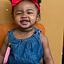 Dior joined the competition — help win amazing prizes! accessory, background, child, curly_hair, cute, denim_outfit, earrings, face, fashion, happy, indoor, person, pigtails, portrait, red_bow, seated, skin, smiling, toddler, young_child