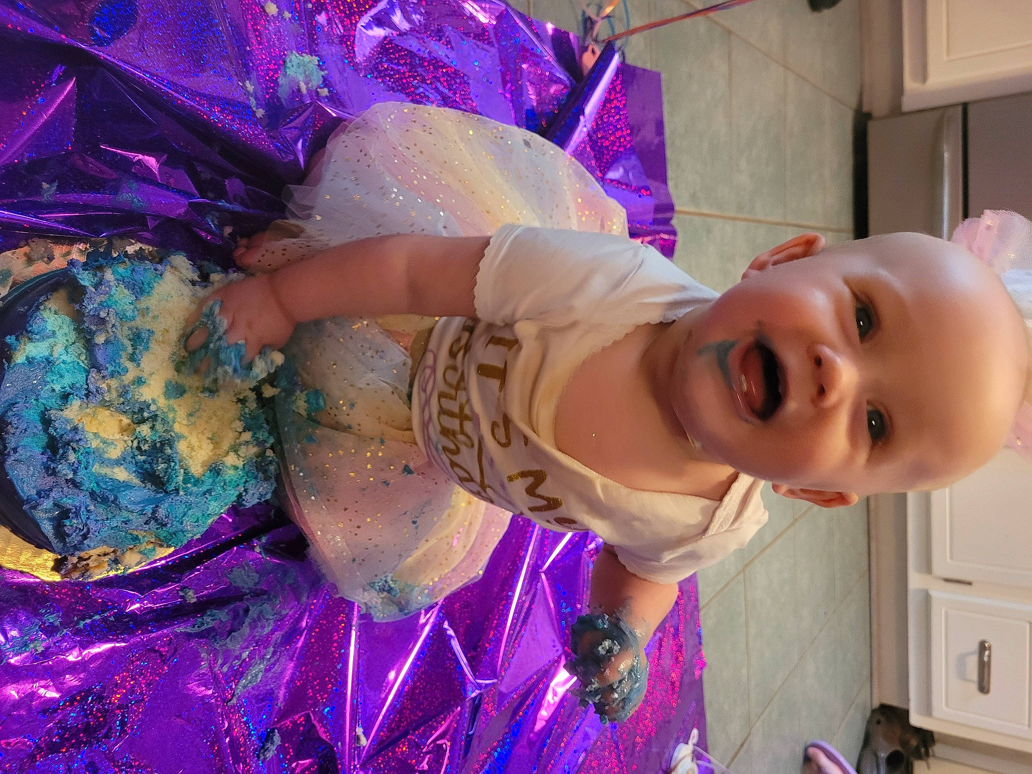 Novalynn is registered to the contest to win money with this photo: baby, cabinetry, child, costume, drawer, dress, event, fashion_accessory, festival, fun, happy, kitchen_appliance, magenta, party, pattern, person, pink, purple, smile, toddler