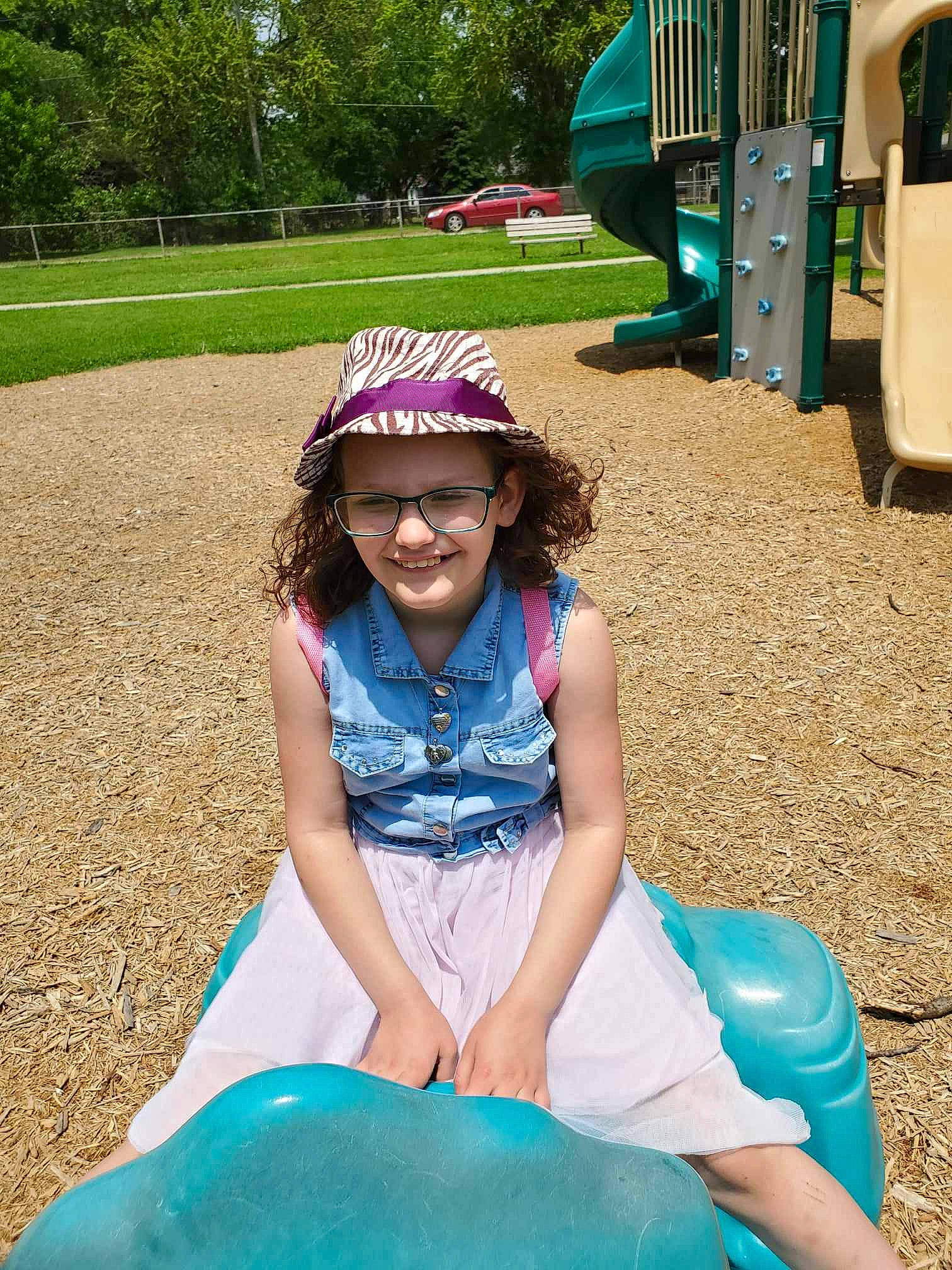 Amethyst is registered to the contest to win money with this photo: blue, fun, glasses, goggles, grass, green, happy, hat, headwear, joy, leisure, outdoor_play_equipment, person, plant, playground, public_space, recreation, smile, summer, sunglasses
