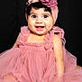 baby, child, infant, pink_dress, headband, flower, smiling, sitting, curly_hair, cute, portrait, happy, studio, tulle, fashion, adorable, closeup, face, young_child, dark_background