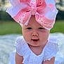 baby, child, bow, pink, white_dress, outdoor, grass, blanket, face, cute, portrait, infant, headwear, closeup, smile, chubby_cheeks, summer, natural_light, young_child, crawling