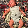 baby, sleeping, onesie, blanket, floral_pattern, infant, peaceful, child, skin, arm, leg, head, cute, rest, comfort, indoors, portrait, small_child, soft, clothing