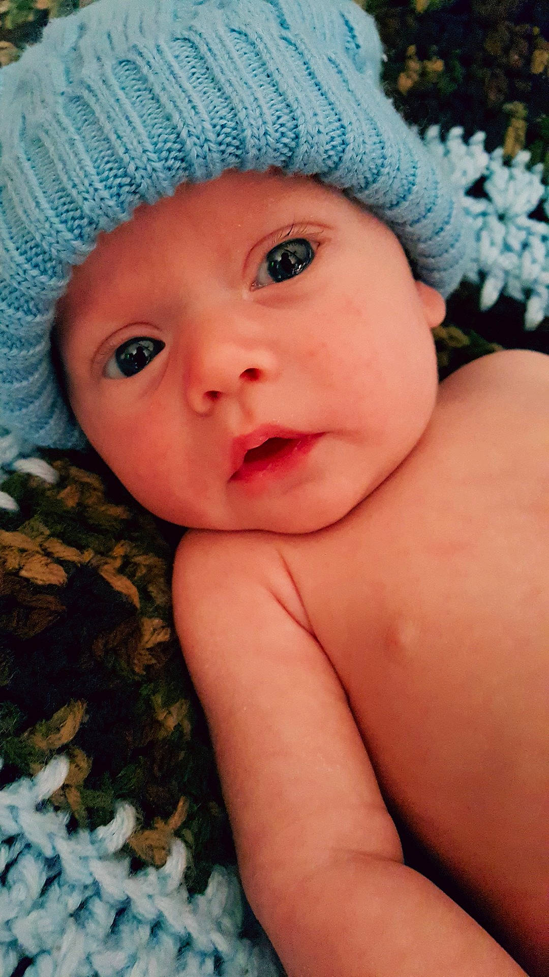 Tucker is registered to the contest to win money with this photo: blurred, boy, cheek, child, close_up, eye, face, hand, headgear, infant, iris, lip, mouth, nose, person, skin, smile, toddler