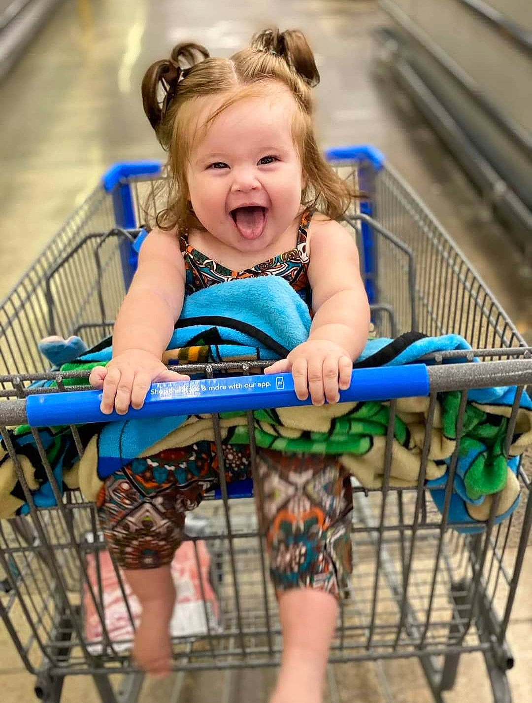 Malani is registered to the contest to win money with this photo: baby_toddler_clothing, child, city, electric_blue, eye, face, fun, hair, happy, head, human_body, leisure, organ, pattern, person, recreation, shorts, sitting, smile, toddler
