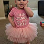 Miranda is registered to the contest to win money with this photo: toddler, child, pink_tutu, pink_shirt, socks, carpet, indoor, cute, smiling, pose, hand_on_cheek, standing, baby, fashion, playful, text_on_shirt, young_child, soft_light, home, portrait