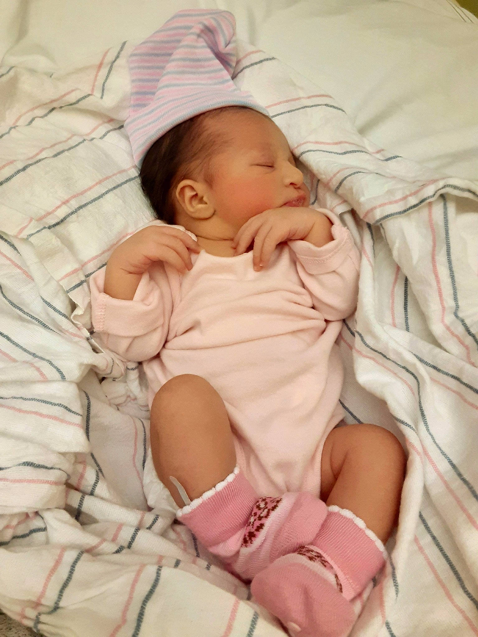 Amila joined the competition — help win amazing prizes! arm, baby, baby_products, baby_safety, baby_sleeping, baby_toddler_clothing, bedtime, cheek, child, comfort, linens, pattern, peach, person, pink, product, sitting, skin, textile, thumb