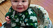 William joined the competition — help win amazing prizes! baby_walker, blonde_hair, child, clothing, cute, face, floor, green_sweater, happy, home, indoor, infant, person, playtime, seat, smile, toddler, toy, wooden_floor, young_child