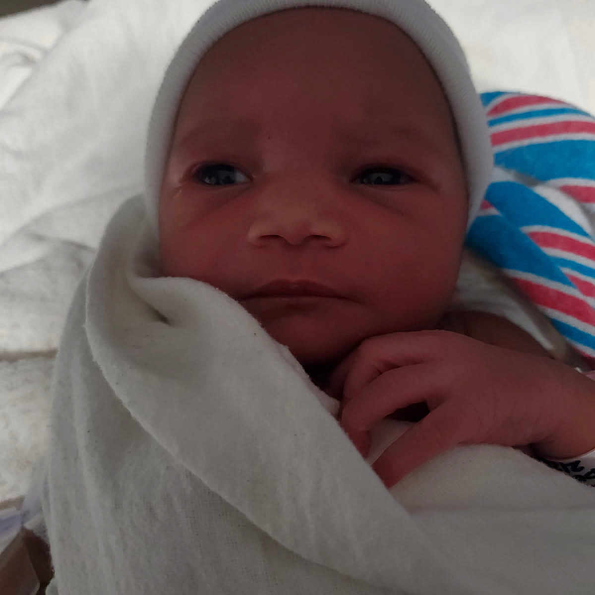 Torian is registered to the contest to win money with this photo: baby, blanket, cap, child, closeup, cozy, cute, face, hand, hospital, infant, newborn, newborn_baby, portrait, resting, skin, sleepy, soft, white, wrapped