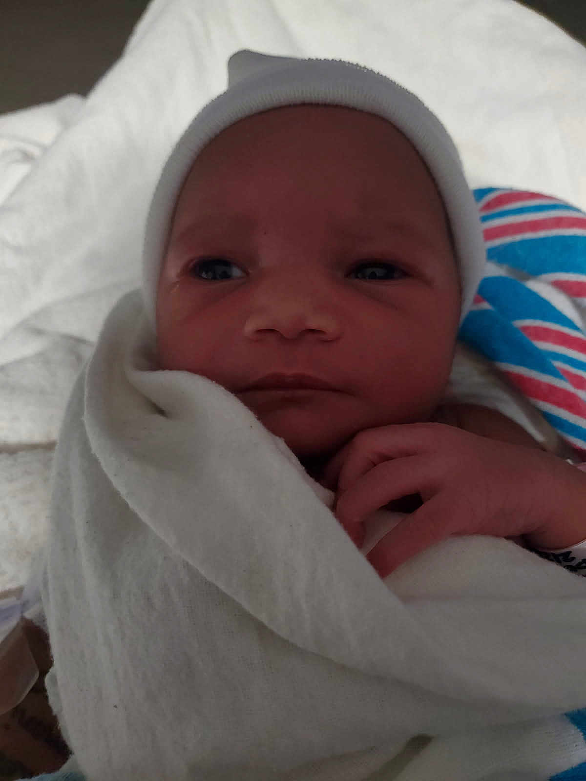 Torian is registered to the contest to win money with this photo: baby, blanket, cap, child, closeup, cozy, cute, face, hand, hospital, infant, newborn, newborn_baby, portrait, resting, skin, sleepy, soft, white, wrapped