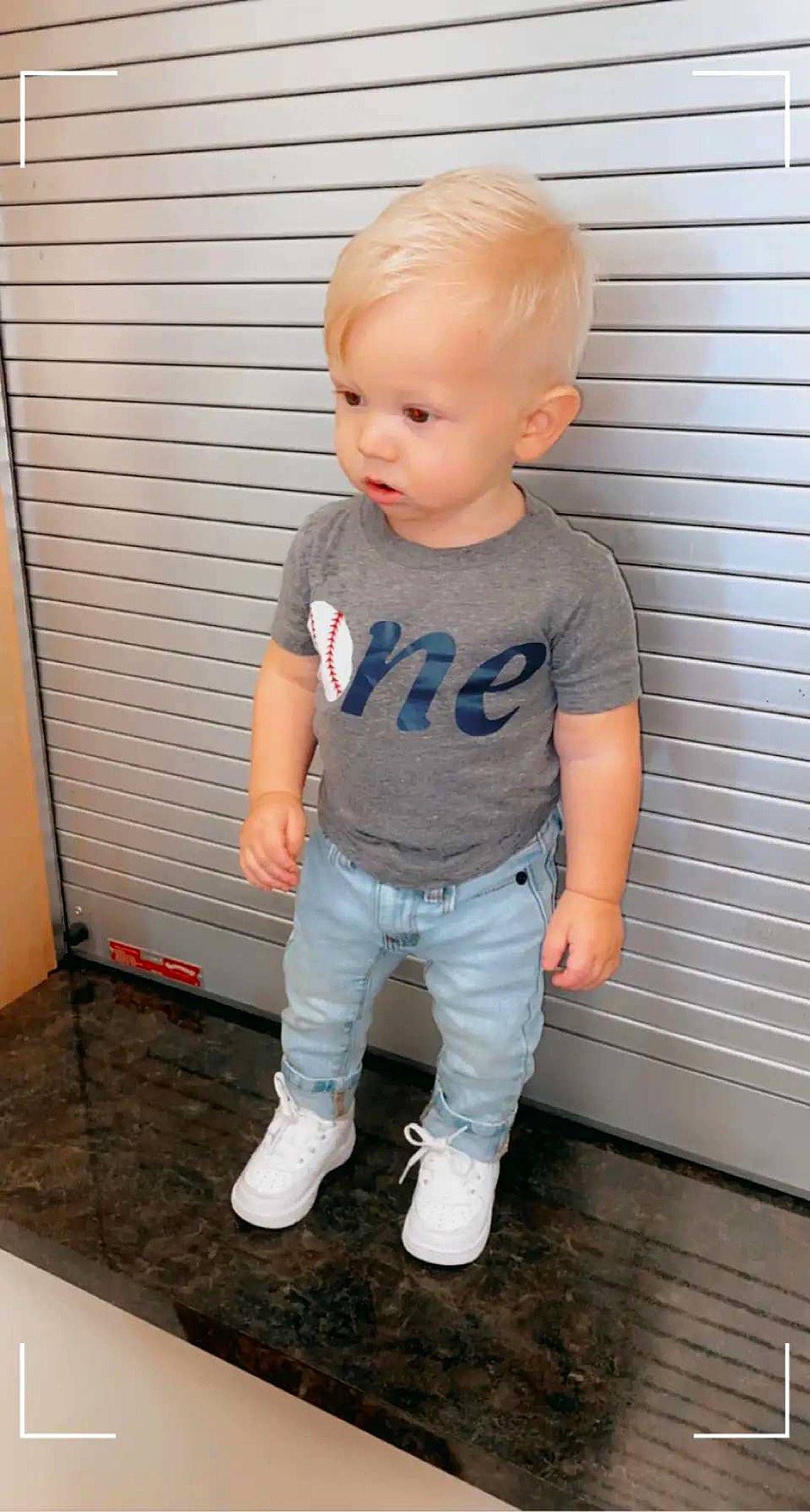 Brexton is registered to the contest to win money with this photo: baby, baby_toddler_clothing, cheek, child, costume, denim, electric_blue, fashion_design, flooring, happy, hardwood, iris, long_sleeved_t_shirt, pattern, person, sleeve, t_shirt, toddler, top, waist