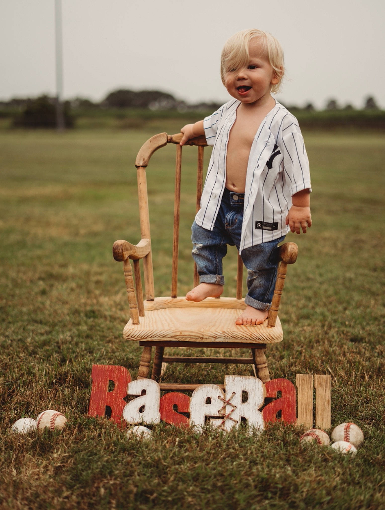 Brexton is registered to the contest to win money with this photo: child, fun, grass, grass_family, grassland, happy, landscape, lawn, mammal, meadow, people_in_nature, person, product, sky, smile, street_fashion, tire, toddler, vertebrate, wheel
