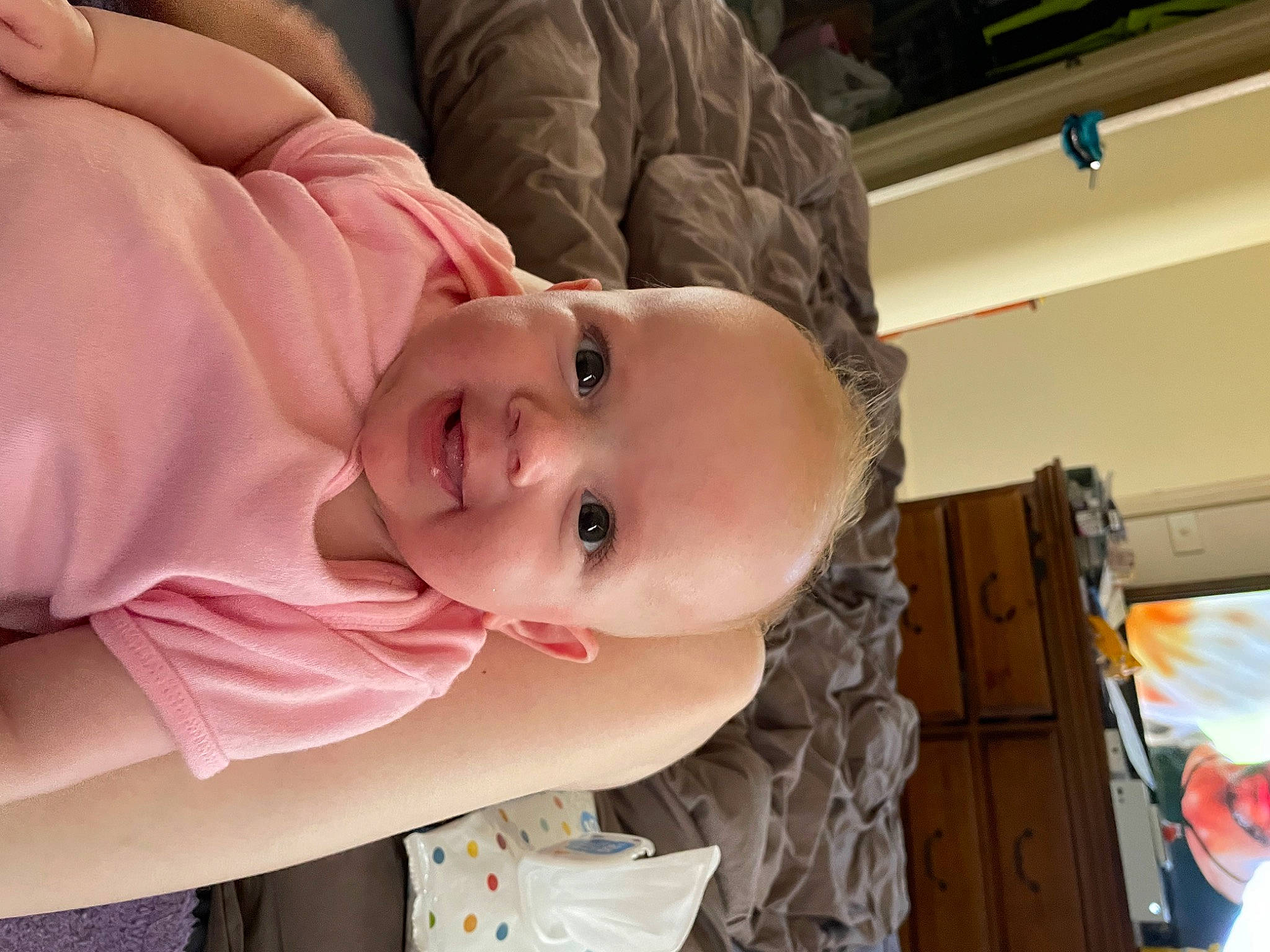 Alexis is registered to the contest to win money with this photo: baby, baby_toddler_clothing, cheek, child, chin, comfort, eye, eyebrow, eyelash, facial_expression, fun, happy, iris, joy, lip, mouth, nose, person, room, skin